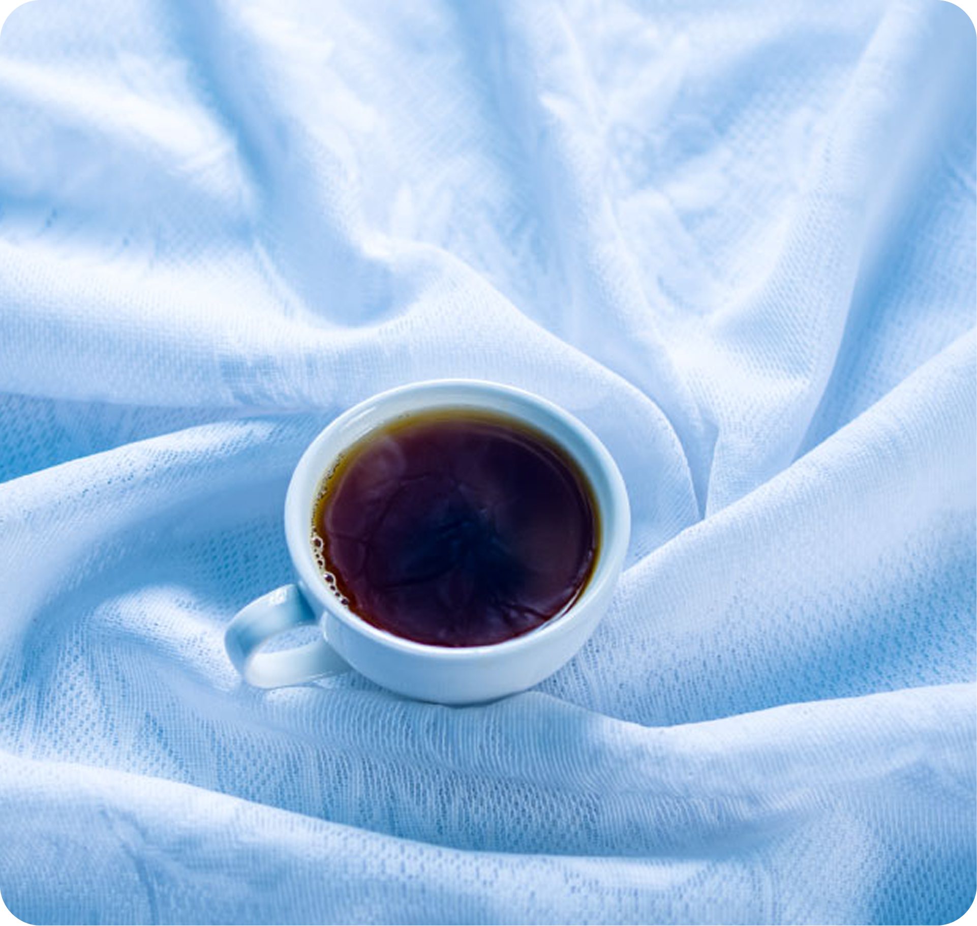 Tea cup on blue fabric